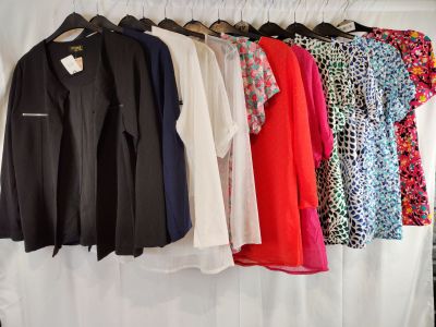 a lot of clothes hanging on a rack in a room
