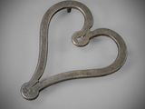 an image of a metal heart shaped object on a white surface