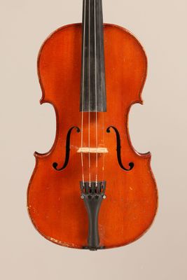 an old violin with a bow hanging from it ' s neck