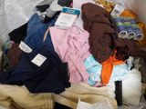 a pile of clothes in a box with a tag on it