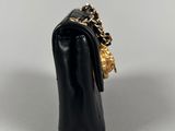 a close up of a black purse with a chain around it