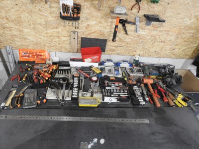 a table with many tools on it in a garage
