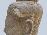 statue of a head of a man with a mohawk on a gray background