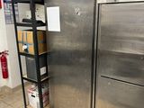 stainless steel refrigerators in a commercial kitchen with boxes on the floor