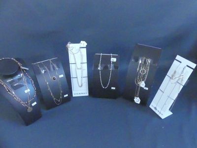several pieces of jewelry are displayed in a display case