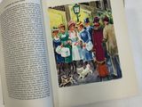 an open book with a picture of a group of people and a dog