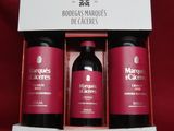 three bottles of body care products in a box on a red background