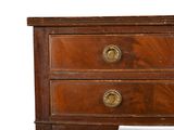 a small wooden chest of drawers with brass knobs on it