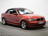 an image of a red bmw convertible parked in a garage