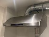 an image of a stainless steel exhaust hood in a bathroom
