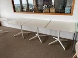 two tables that are sitting in front of a mirror