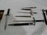 several different types of knives are displayed on a white surface