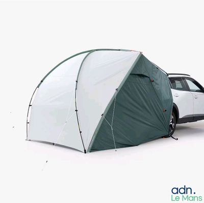 a car parked next to a tent in the snow