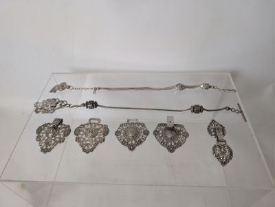 a glass table with a lot of silver items on it