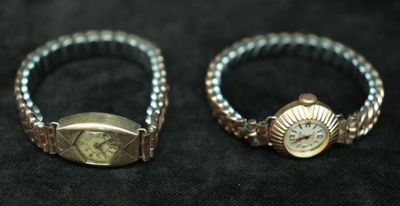 pair of silver and gold rings on a black background