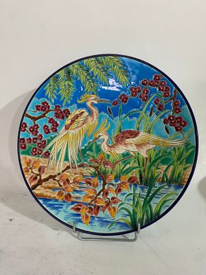 a plate with a painting of birds and flowers on it