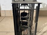 a clock that is sitting on the ground in front of a wall