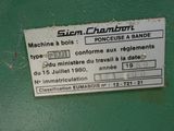 a label on the side of a machine that is on a green wall