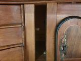 a wooden cabinet with a door and a drawer on it