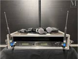 two microphones sitting on top of a rack on a table
