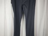 a pair of dark blue pants hanging on a white curtain