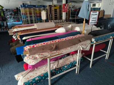 a lot of beds that are sitting in a room