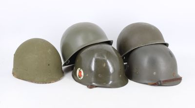 three helmets are lined up in a row on a white surface