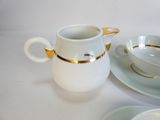 two cups and saucers on a white table