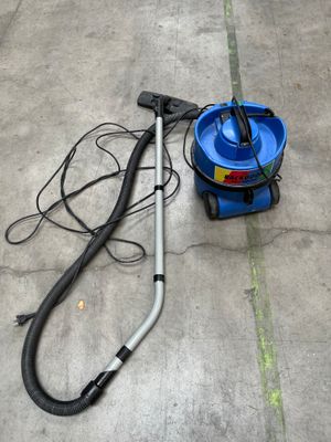 a blue vacuum and a blue bucket on the ground