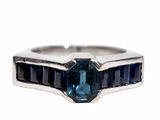 an image of a ring with a blue stone in it