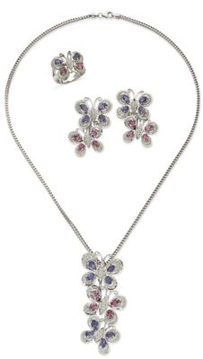 a necklace and earring set with purple and blue stones