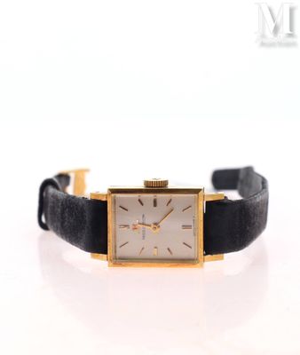 a close up of a watch on a white surface with a white background