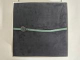 a black book with a green ribbon on it