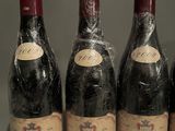 six bottles of wine are lined up on a table