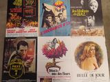 various movie posters on a table in a room