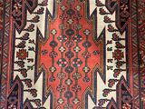 an antique persian rug with a red and blue design
