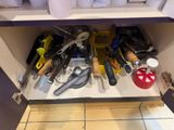 a picture of a kitchen cabinet with tools in it