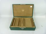 a green case with a lot of brushes inside of it