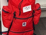 a red backpack sitting on top of a folding chair