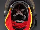 the back of a helmet with a red, yellow, and black cover