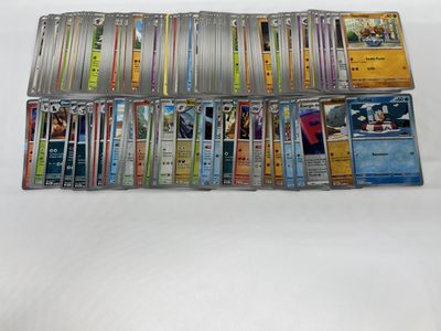 a lot of pokemon trading cards on the table