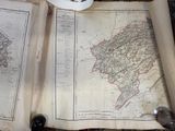an old map on the table next to a cup of coffee