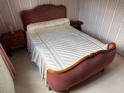 a bed with a quilt on top of it in a room
