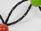 a close up of a red and green object on a white surface