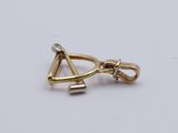 two gold - plated charms with a triangle on a white background