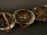 three helmets are lined up in a row on a black surface