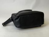 a black leather bag on a white surface with a white background