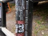 a black pole with stickers on it next to a truck