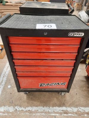 a close up of a red and black tool box on a table