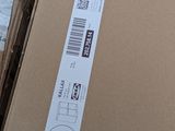 a cardboard box with a sticker on it sitting on the floor